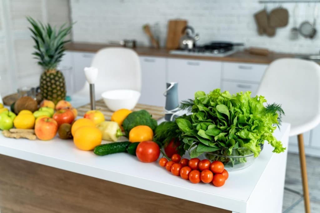 Fresh fruits and vegetables arranged on a kitchen counter